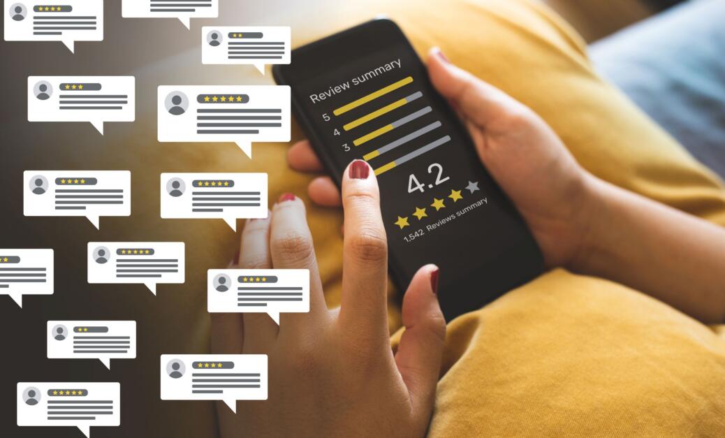 Person holding smartphone displaying a review summary with a rating of 4.2 stars and multiple comment icons, illustrating the impact of online reviews on hotel reputation management and customer experience in the hospitality industry.
